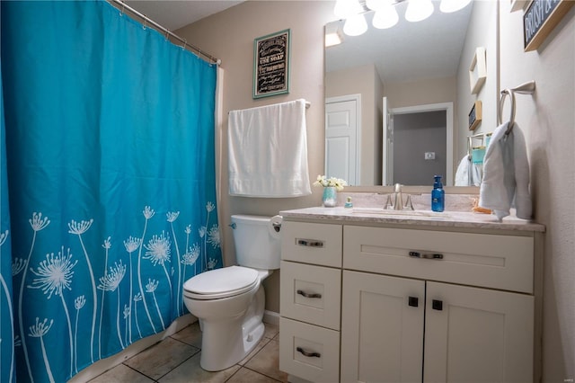 bathroom featuring vanity, tile patterned floors, and toilet