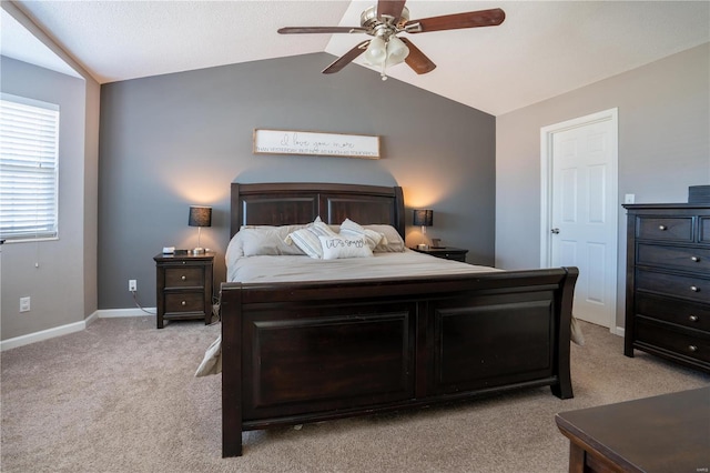 bedroom featuring vaulted ceiling, light colored carpet, and ceiling fan