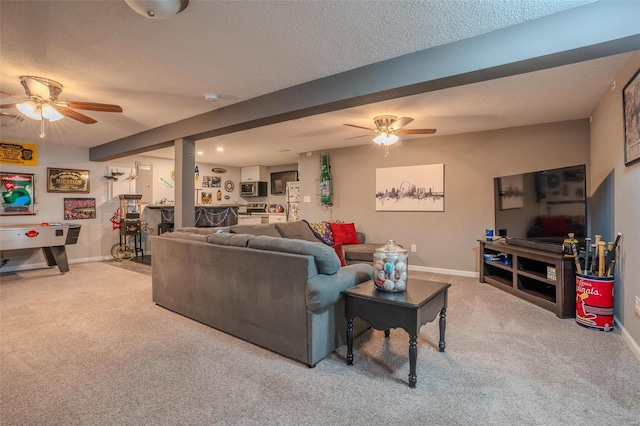 living room featuring ceiling fan, light carpet, and a textured ceiling