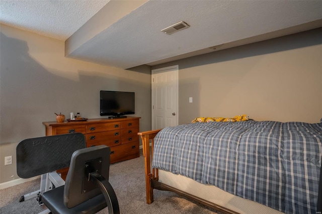 carpeted bedroom with a textured ceiling