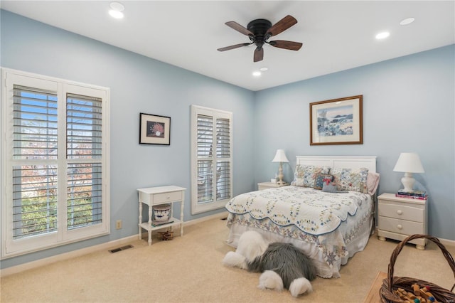 bedroom with light carpet and ceiling fan