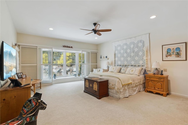 bedroom with ceiling fan and light carpet