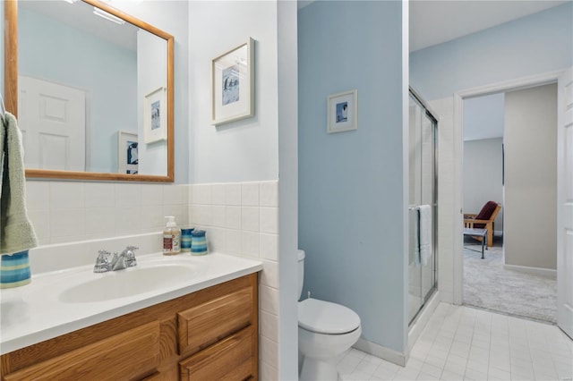 bathroom featuring walk in shower, tile patterned floors, toilet, tile walls, and vanity