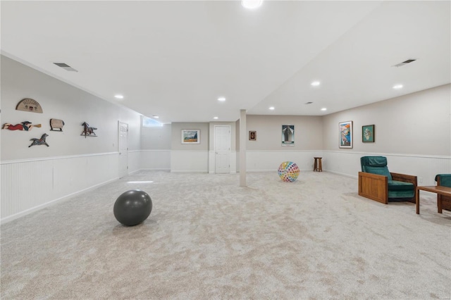 workout room featuring light carpet