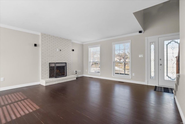 unfurnished living room with ornamental molding, a fireplace, and dark hardwood / wood-style flooring