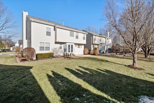 rear view of house featuring a yard