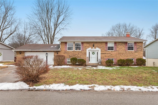 view of front of home featuring a garage and a front lawn