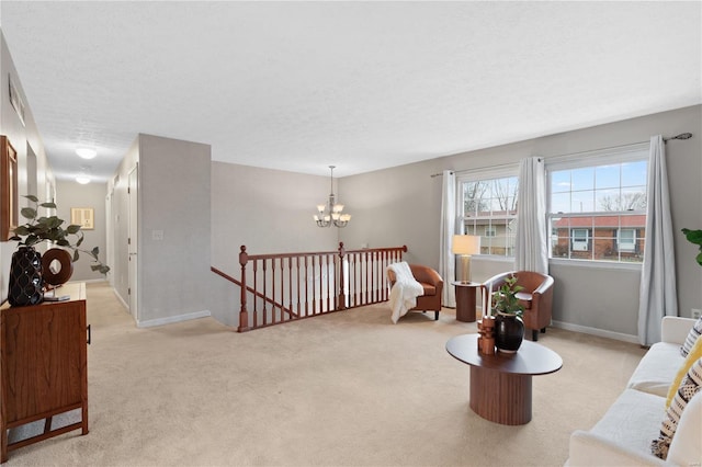 sitting room with light colored carpet, a textured ceiling, and a chandelier