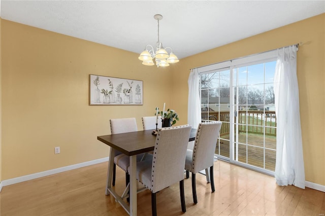 dining room featuring an inviting chandelier and light hardwood / wood-style flooring