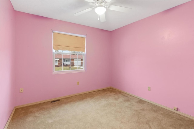 carpeted spare room with ceiling fan