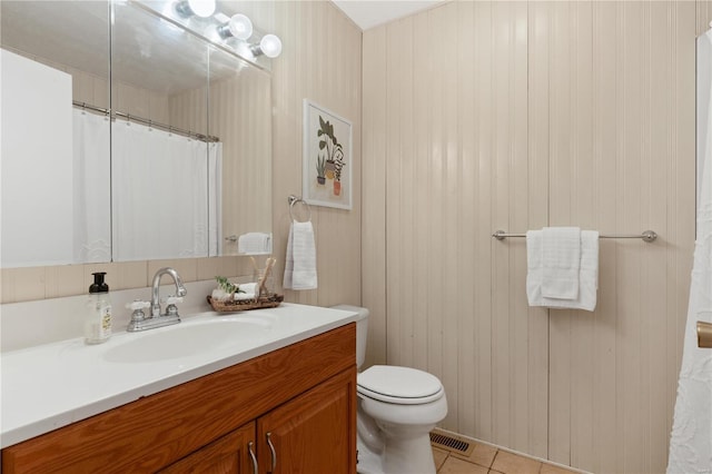 bathroom with tile patterned floors, vanity, and toilet