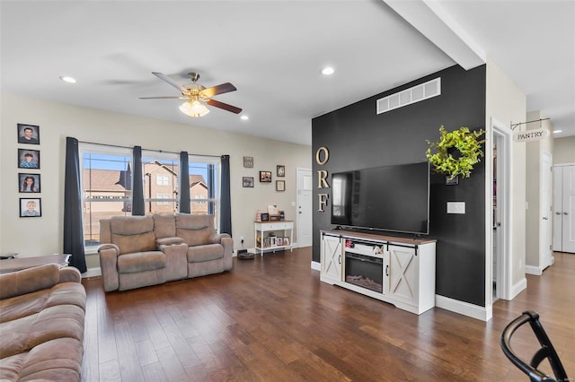 living room featuring dark hardwood / wood-style floors and ceiling fan