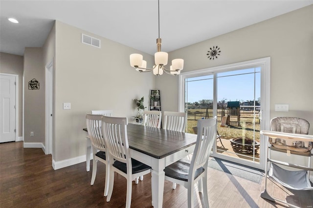 dining space featuring an inviting chandelier and dark hardwood / wood-style floors