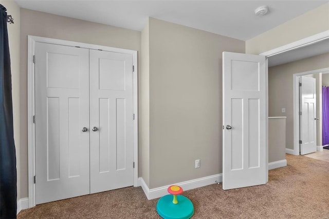 interior space with light colored carpet and a closet