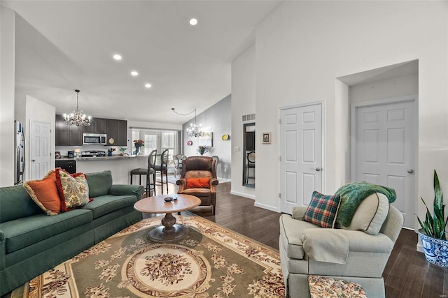 living room featuring an inviting chandelier, high vaulted ceiling, and dark wood-type flooring