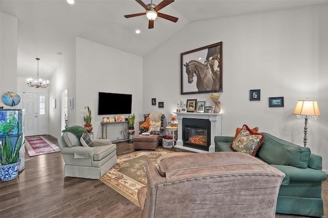 living room featuring ceiling fan with notable chandelier, wood-type flooring, and high vaulted ceiling