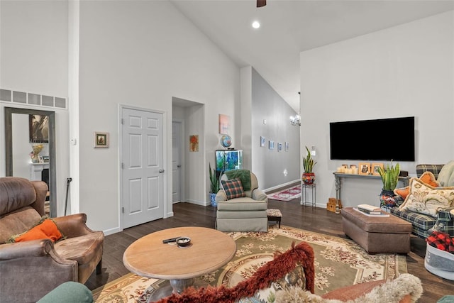 living room featuring dark hardwood / wood-style floors and high vaulted ceiling