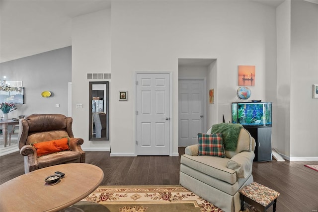 living room featuring dark wood-type flooring and high vaulted ceiling