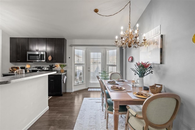 dining room featuring dark wood-type flooring and vaulted ceiling