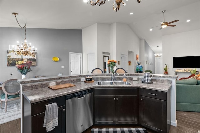 kitchen with sink, a kitchen island with sink, light stone counters, dark hardwood / wood-style flooring, and stainless steel dishwasher