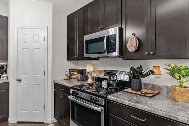 kitchen featuring appliances with stainless steel finishes and dark brown cabinets