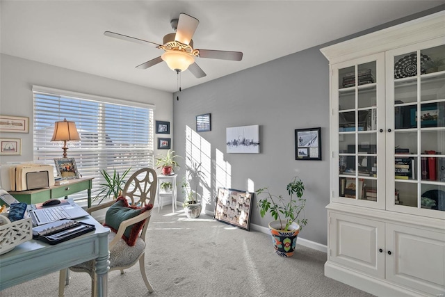 carpeted home office with ceiling fan