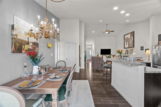 dining room featuring high vaulted ceiling, dark hardwood / wood-style flooring, and ceiling fan with notable chandelier