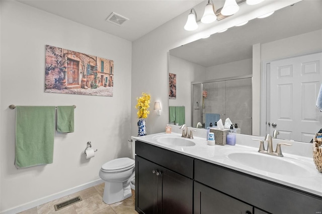 bathroom with a shower with door, vanity, tile patterned floors, and toilet