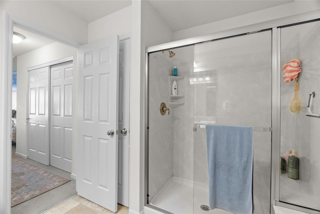 bathroom featuring a shower with shower door