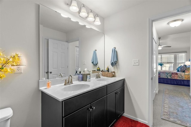 bathroom with vanity, toilet, and ceiling fan