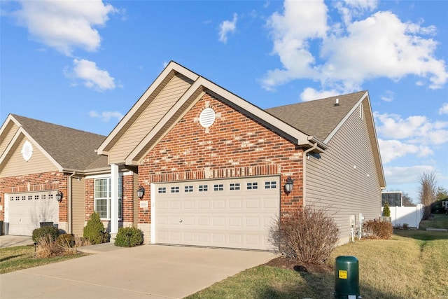 view of property with a garage and a front yard