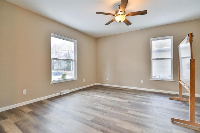 spare room featuring light hardwood / wood-style floors and ceiling fan