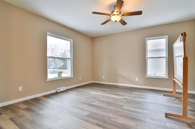 empty room featuring light hardwood / wood-style flooring and ceiling fan