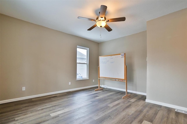 empty room with ceiling fan and hardwood / wood-style floors