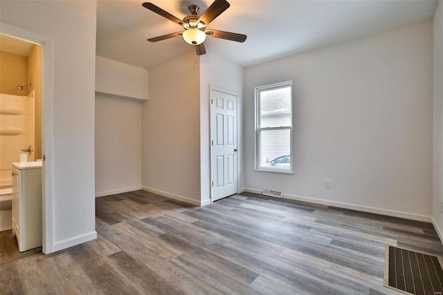 unfurnished bedroom featuring dark hardwood / wood-style flooring, ceiling fan, a closet, and ensuite bathroom