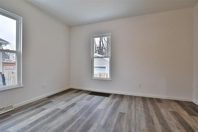 spare room with dark wood-type flooring