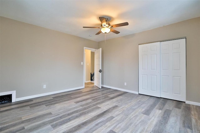 unfurnished bedroom featuring a closet, ceiling fan, and light hardwood / wood-style flooring