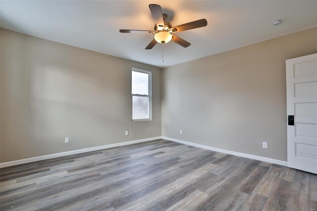 spare room featuring hardwood / wood-style flooring and ceiling fan