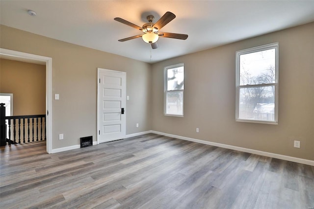 spare room featuring hardwood / wood-style floors and ceiling fan