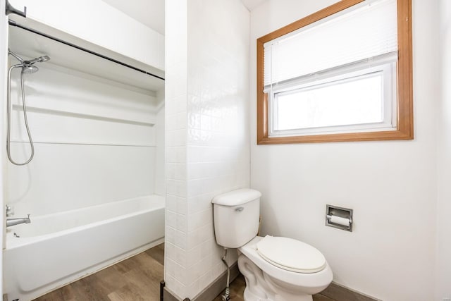 bathroom featuring hardwood / wood-style flooring,  shower combination, and toilet