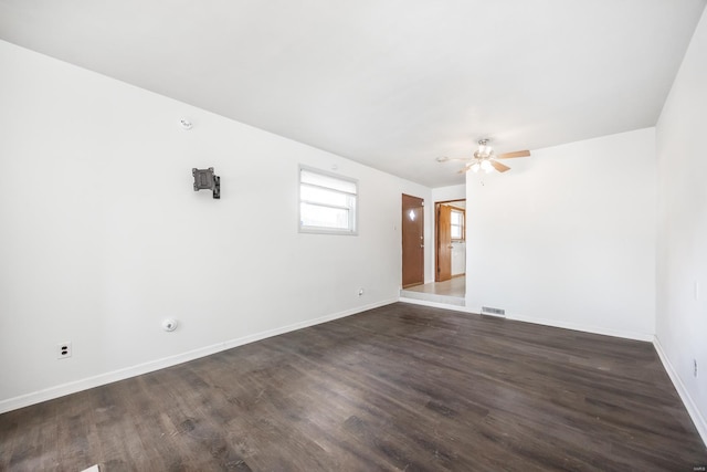 unfurnished room with ceiling fan and dark hardwood / wood-style flooring