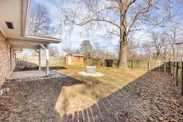 view of yard featuring a storage shed and a patio