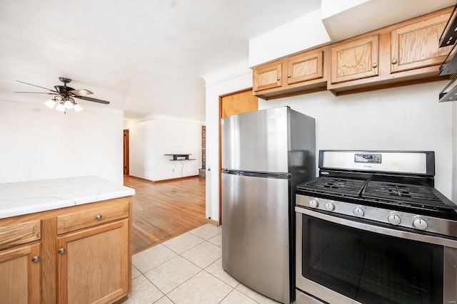 kitchen with ceiling fan, light tile patterned floors, and stainless steel appliances