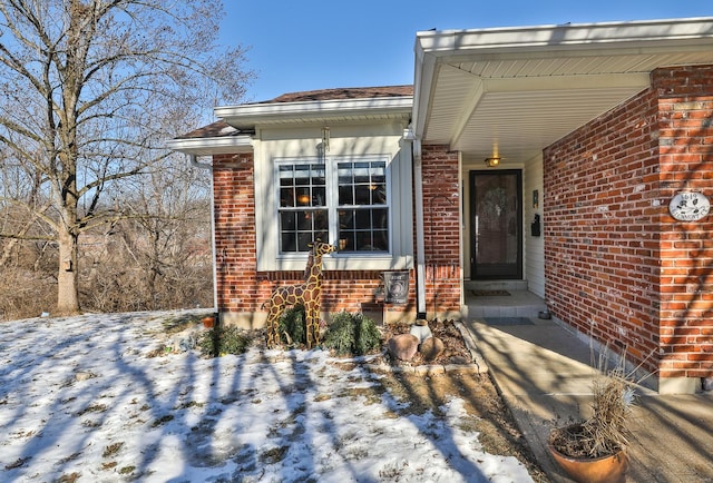 view of snow covered property entrance