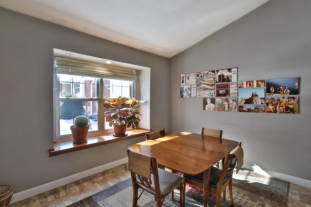 dining space with vaulted ceiling