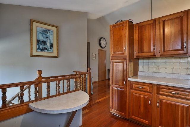 kitchen featuring dark hardwood / wood-style flooring and backsplash