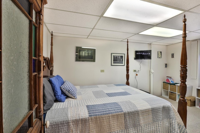 carpeted bedroom featuring a paneled ceiling