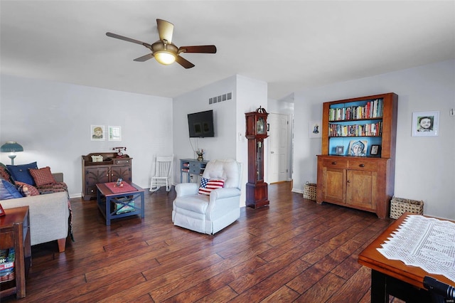 living room featuring dark hardwood / wood-style flooring and ceiling fan