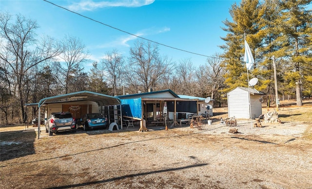 exterior space featuring a carport and a storage unit