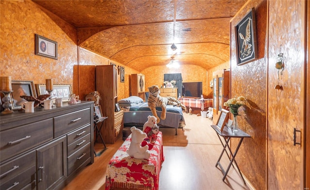 bedroom with wood-type flooring and lofted ceiling